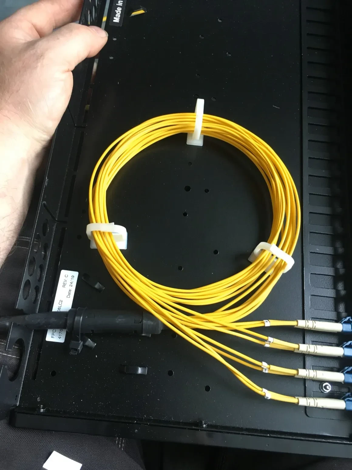 Coiled yellow fibre optic cables and connectors