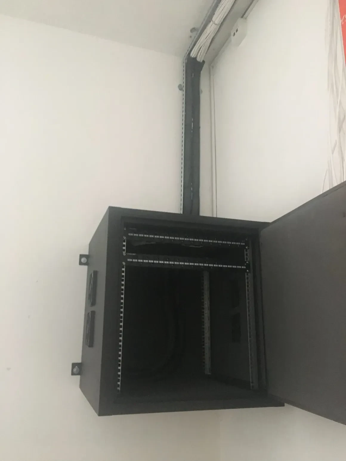 Open wall-mounted network rack installation