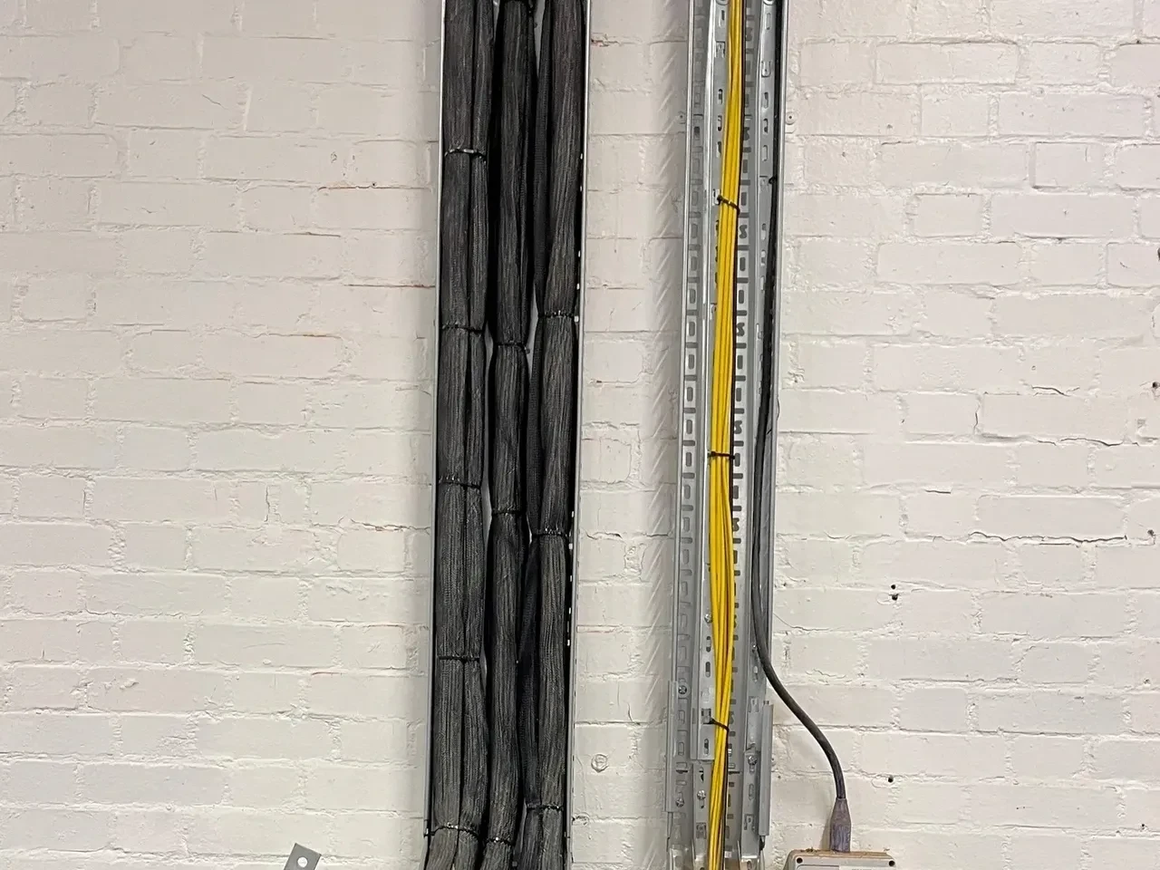 Wall-mounted cable containment and fibre cabling